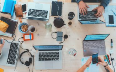 Laptops on desk of people onboarding