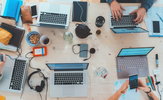 Laptops on desk of people onboarding